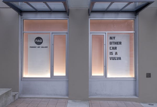 Two large fliers are installed in the CAG’s window spaces. The flier on the left mimics CAG’s circular-shaped logo. It says FAG, Feminist Art Gallery. The other one is also a text-based work.  