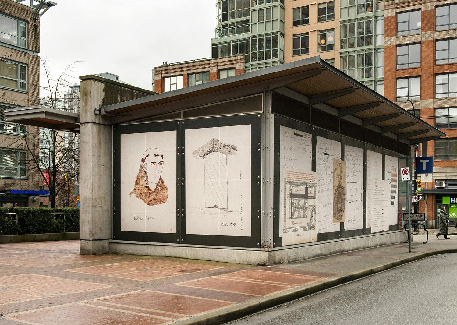 An exterior view of a train station displaying Sandoval’s work printed in vinyl. The work includes a collage of scanned archival documents on one side of the station and scanned drawings on the other. 