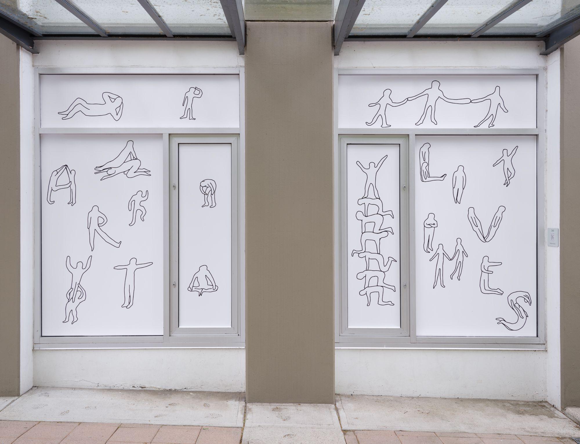 A pair of windows featuring line drawn figures engaged in various activities. Some of the figures spell out “art” and “lives” with their bodies.