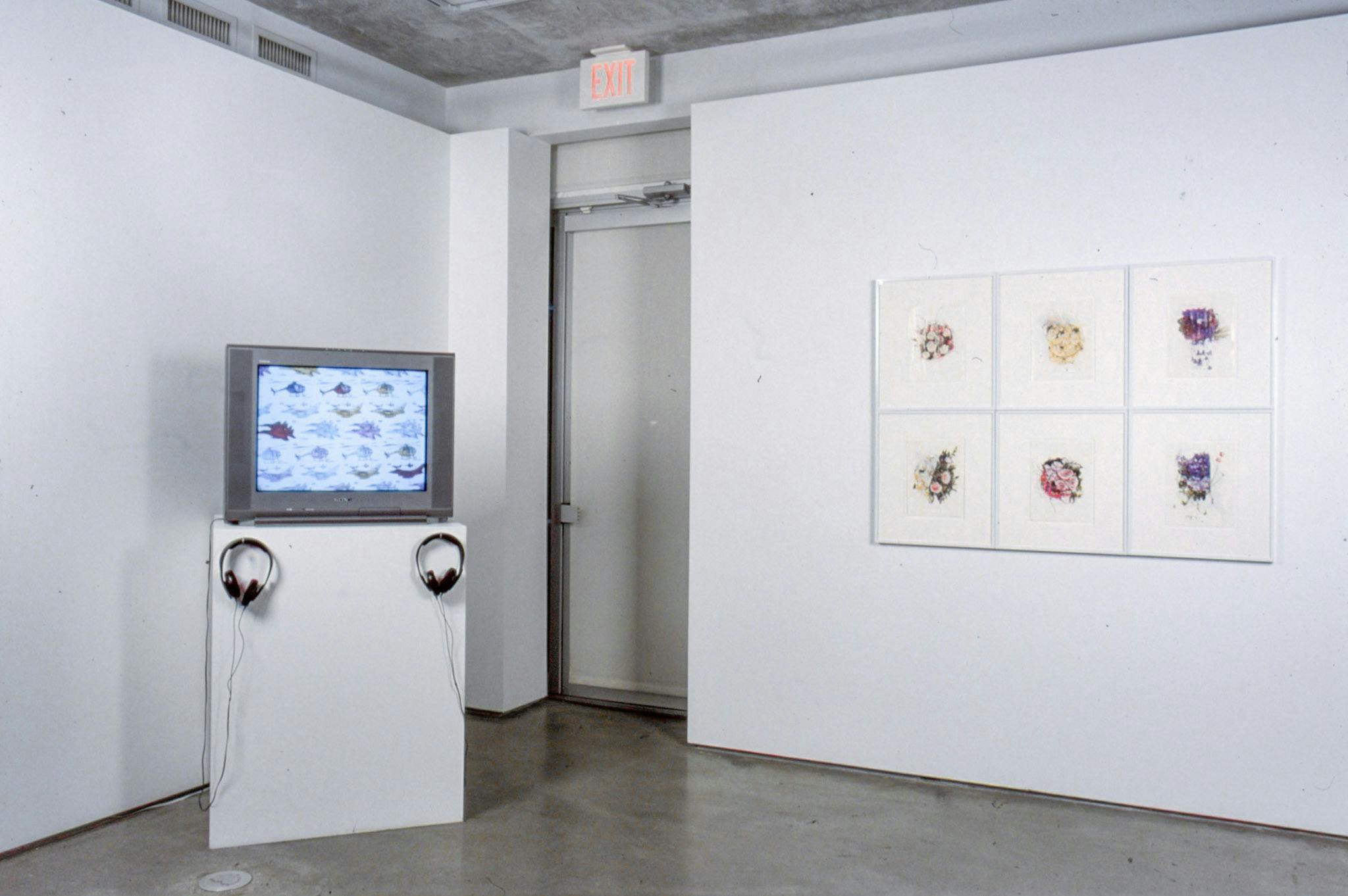 An installation image of artworks in a gallery. A CRT TV on a pedestal shows multiple drawings of aircraft. On a wall, six drawings of flowers are mounted. 