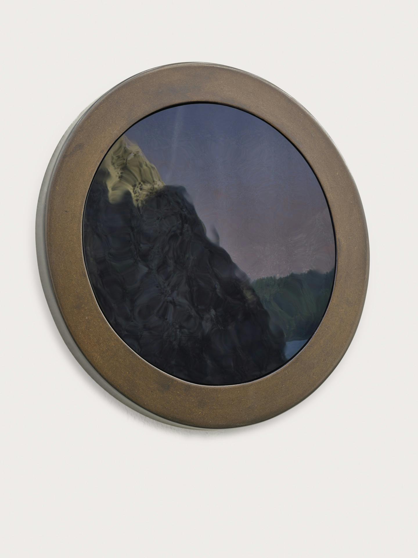 A framed black mirror by Kathy Slade reflecting a tapestry depicting a large rock.