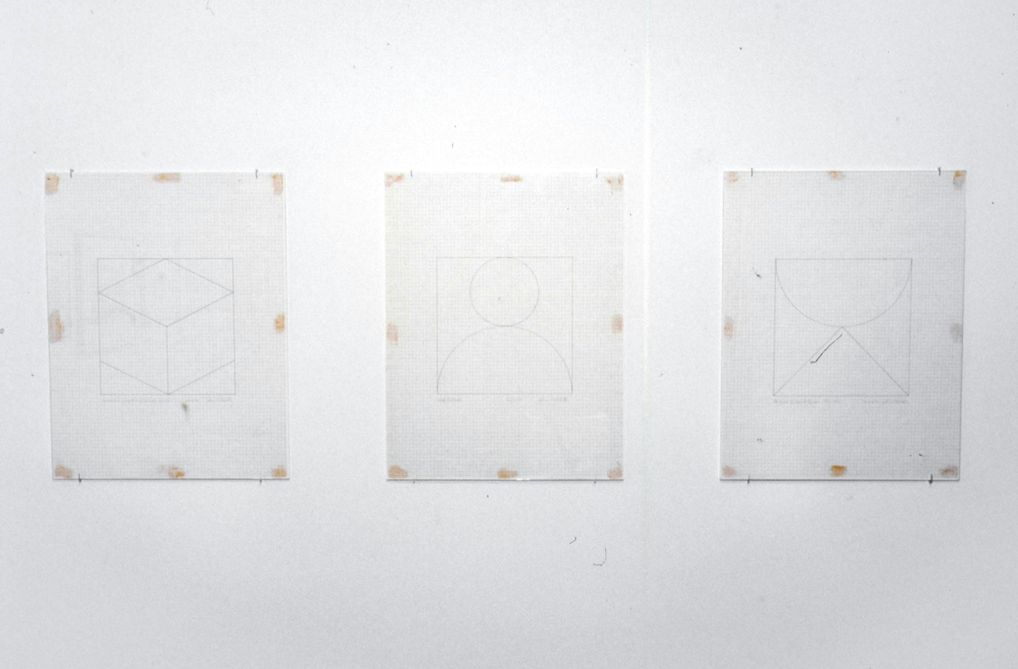 A set of three drawings are mounted on the wall. They all depict geometric shapes that could be found in geometry exams. None of the drawn shapes are shaded. 