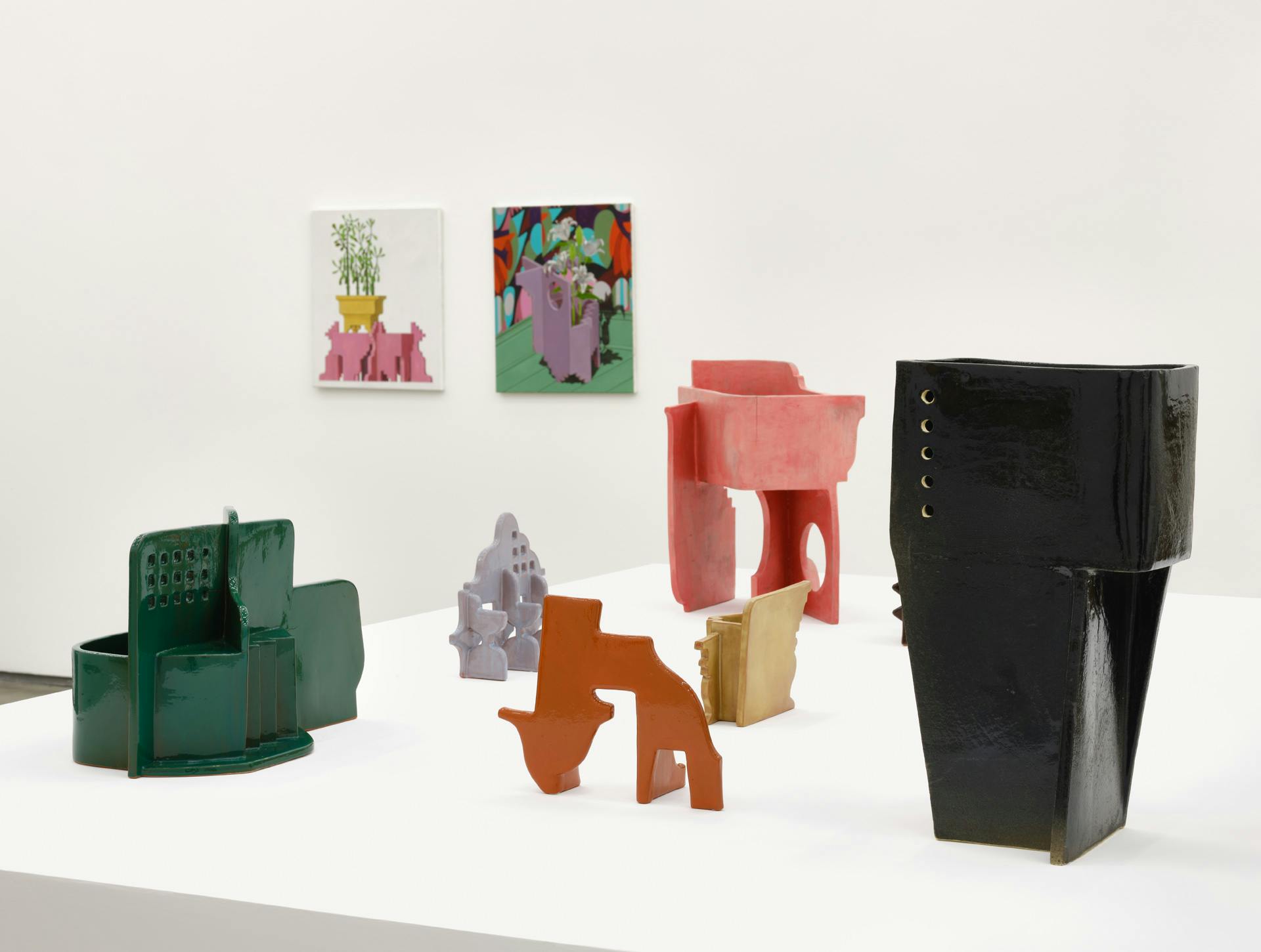 Installation image of Alex Morrison's sculptures and paintings in a gallery.