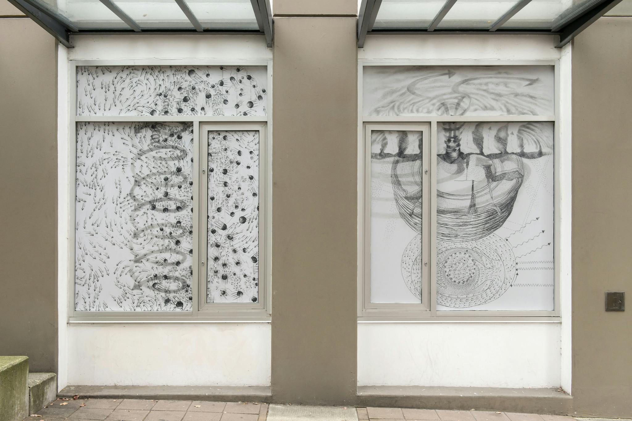 Image of two vinyl prints of black & white graphite drawings in two windows. The left has dynamic swirls of arrows and circles and the right has a stack of plates converging with a cloud-like shape.  