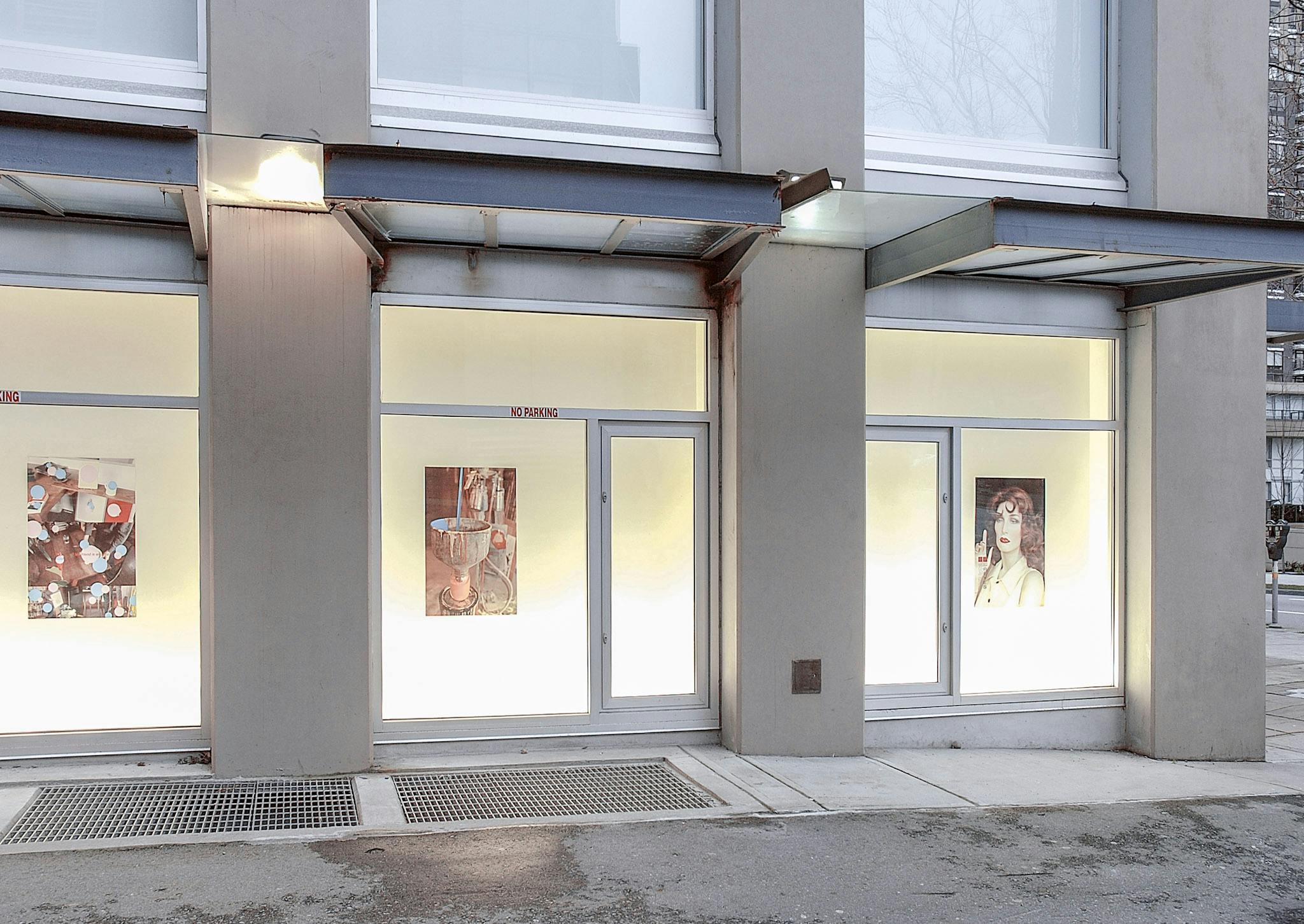 Each of the CAG exterior window spaces displays a coloured poster made by Andrew Reyes. Images used in two of them were cropped from paintings. The walls behind those windows are pastel yellow.