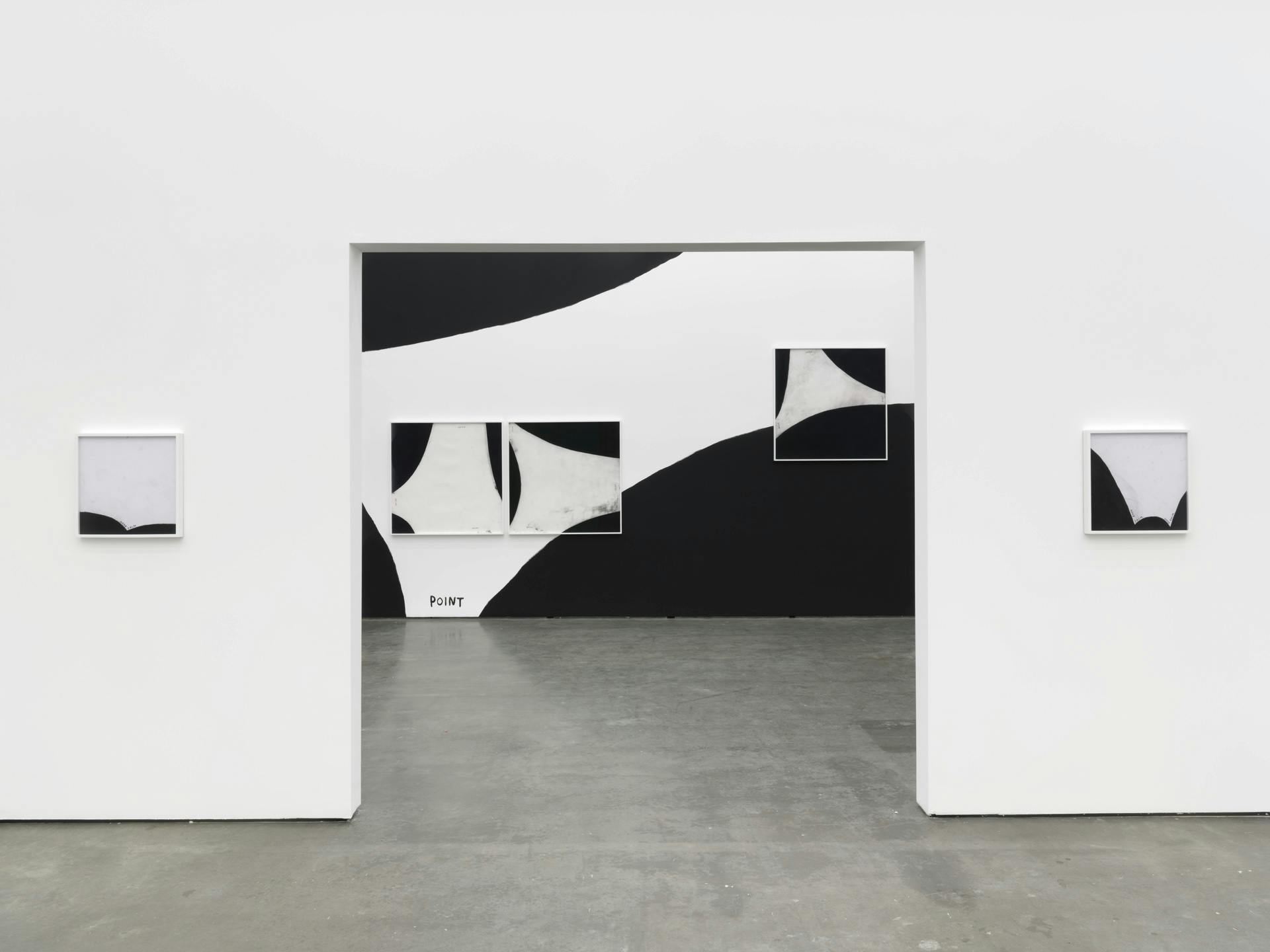 Two black and white drawings by Christine Sun Kim on a wall with an opening, through which a wall painting featuring the word "point" and three other drawings by Kim are visible.
