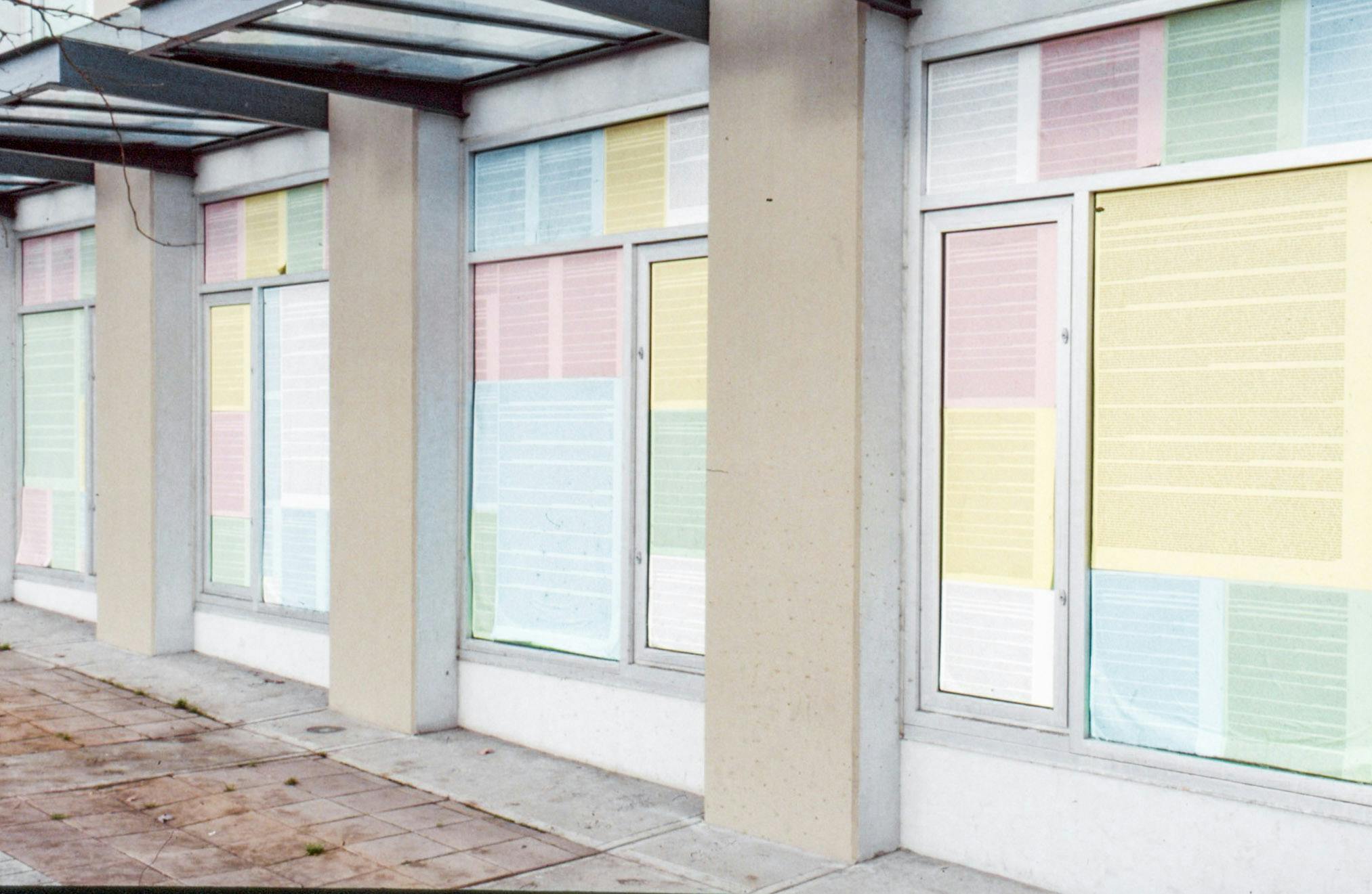 Texts printed on sheets of colourful paper cover the entire windows on CAG’s first floor. Some papers are much larger than the others. They are pink, yellow, blue, green, or white.