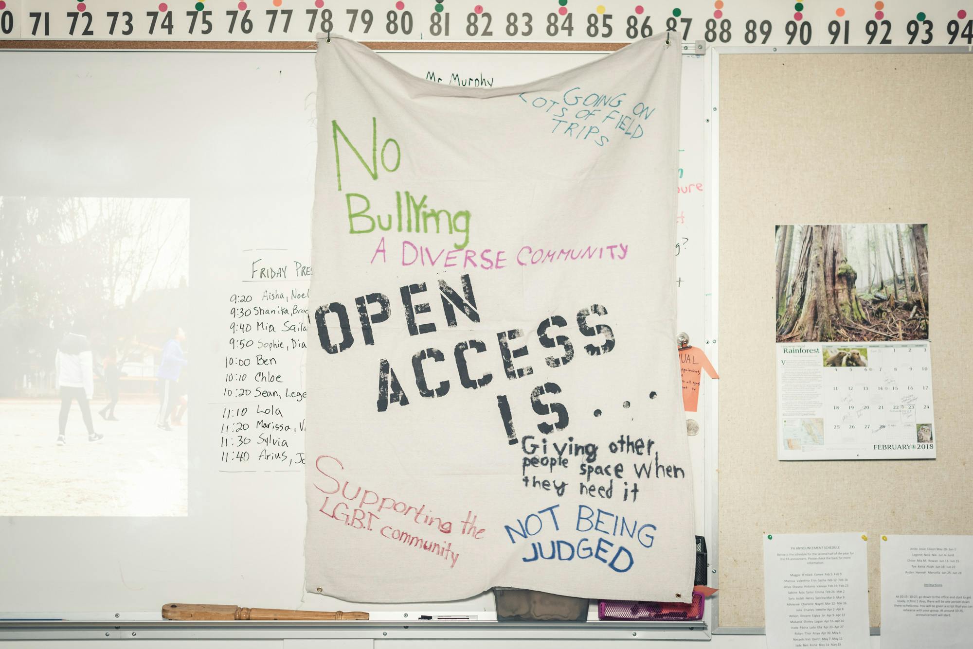A photograph of a piece of white cloth on a wall of a classroom. A phrase, '"open access is..." is printed in the middle of the cloth, and other handwritten ideas, including "not being judged" are written in the margins. 