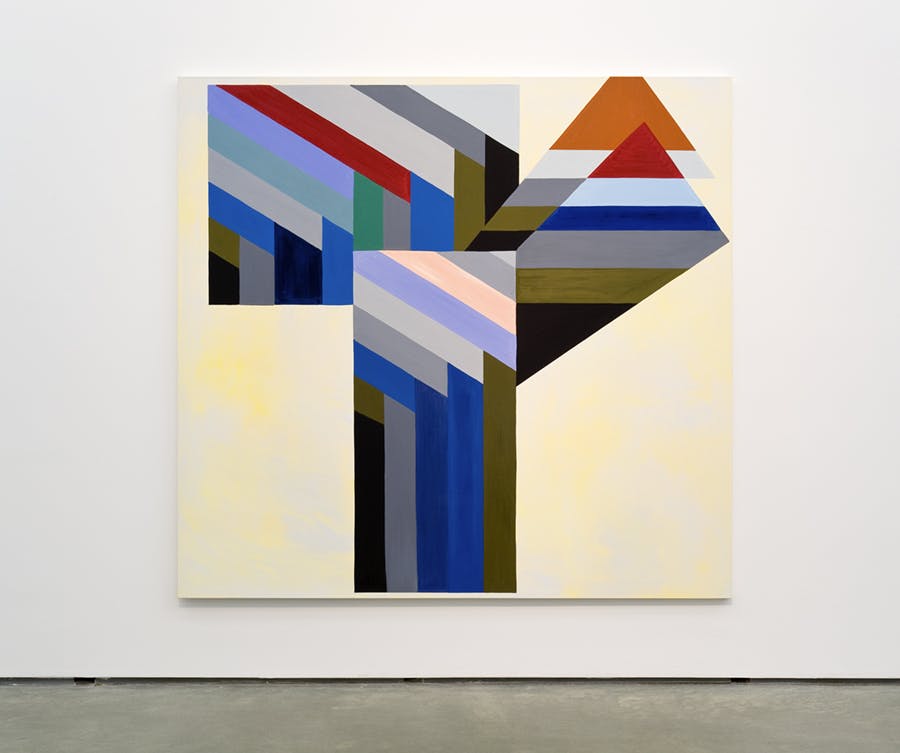 A large-scale artwork mounted on a gallery wall. The background is an uneven distribution of yellow. Rectangular shapes made up of bold, patterned stripes of various colours create the foreground.