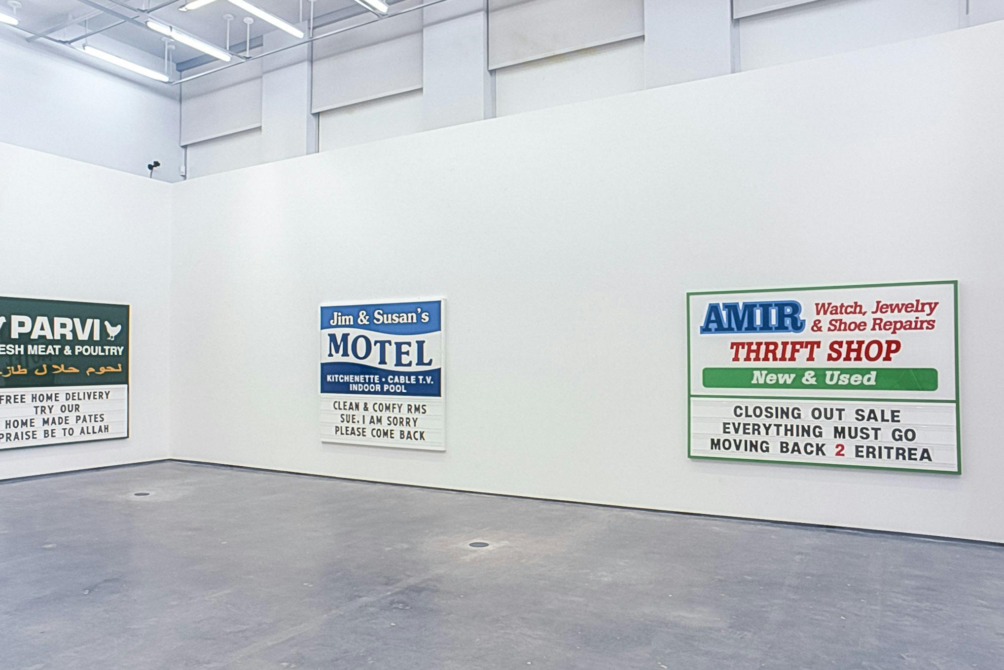 Ken Lum’s works are mounted on the gallery walls. They are text based two dimensional works with colourful advertisement posters. Their sizes vary, but many of them are larger than human scale.