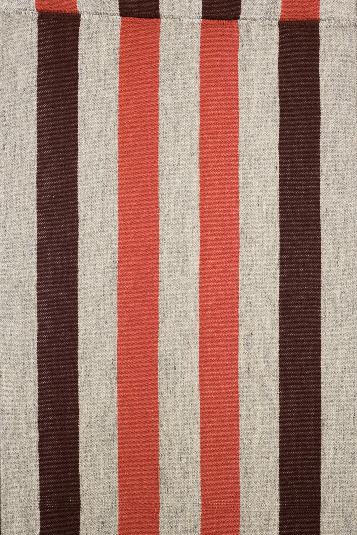 A close view of a woven textile which has a striped pattern of alternating brown, orange and tan colours.