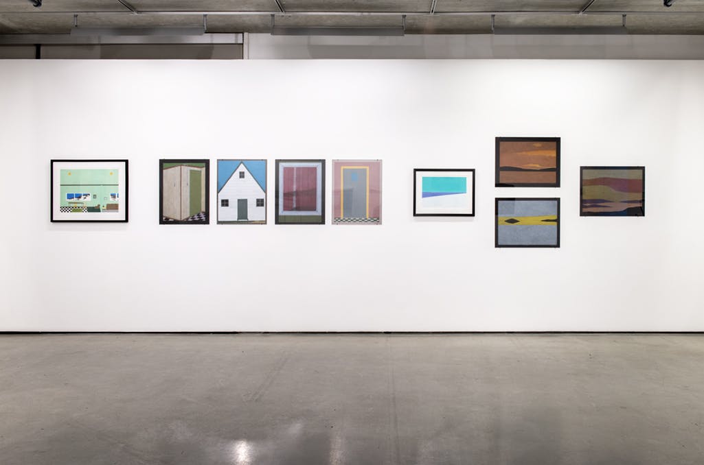 Multiple drawings by Itee Pootoogookhang on gallery walls. Nine framed works are visible in this photograph. Several depict doorways, with others focusing on abstract landscapes.