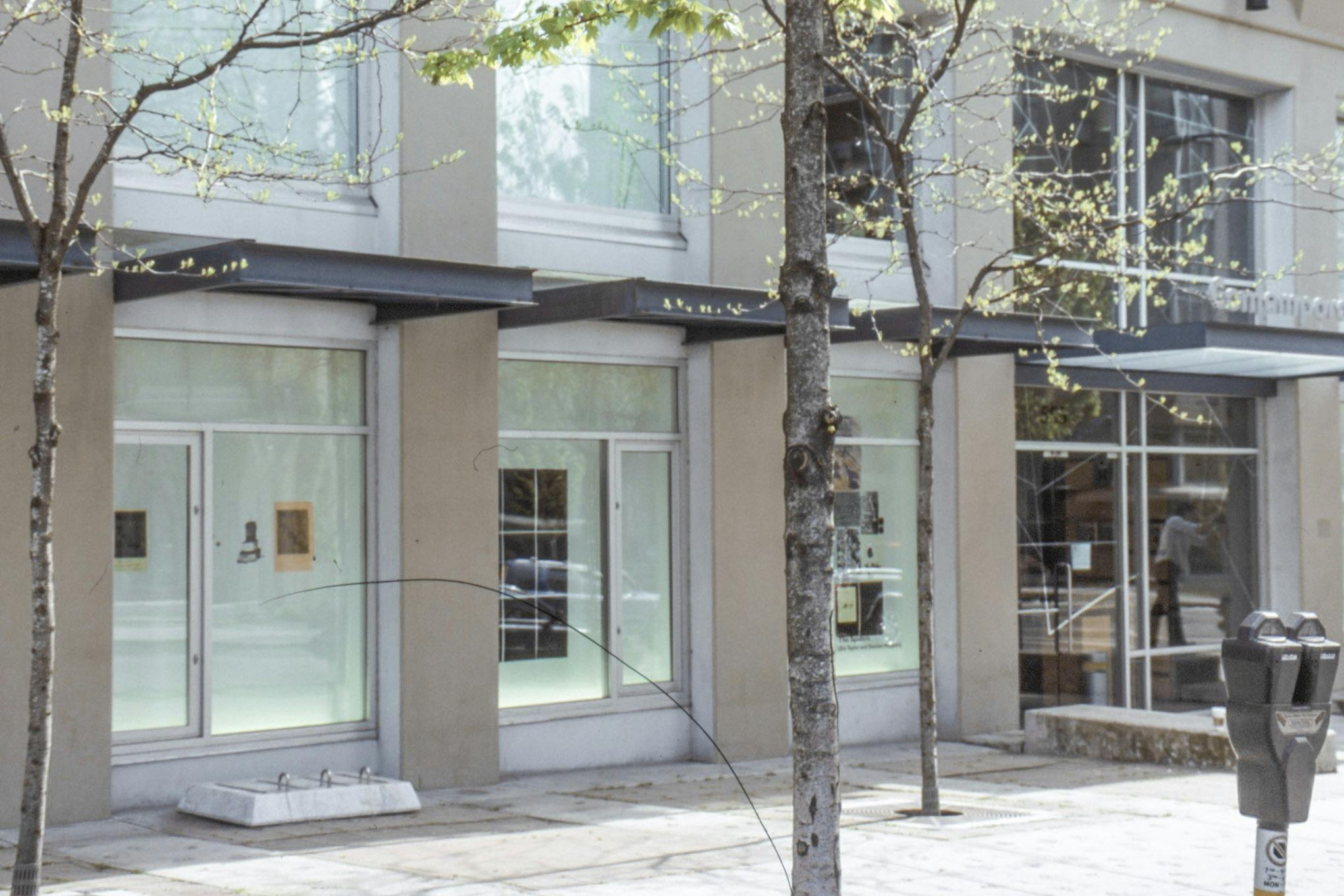 An install image of two-dimensional works in CAG’s window spaces facing Nelson Street. 