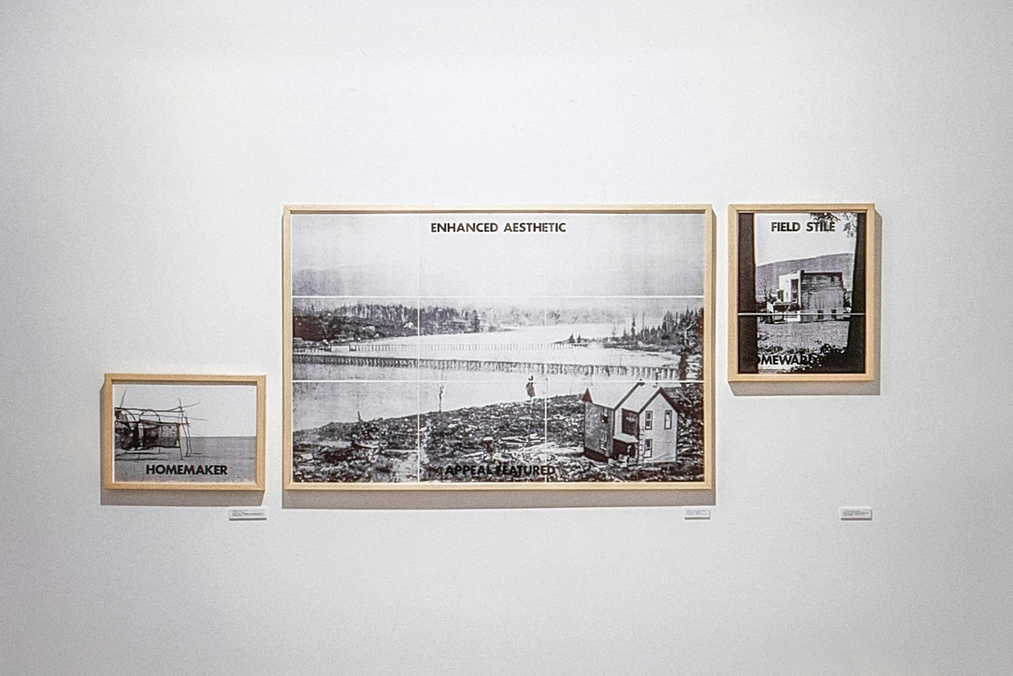 A large photo with 2 smaller photos on either side, all in natural wood frames, on a wall. All the photos show black and white landscapes with small buildings in the corner, and phrases in black text.