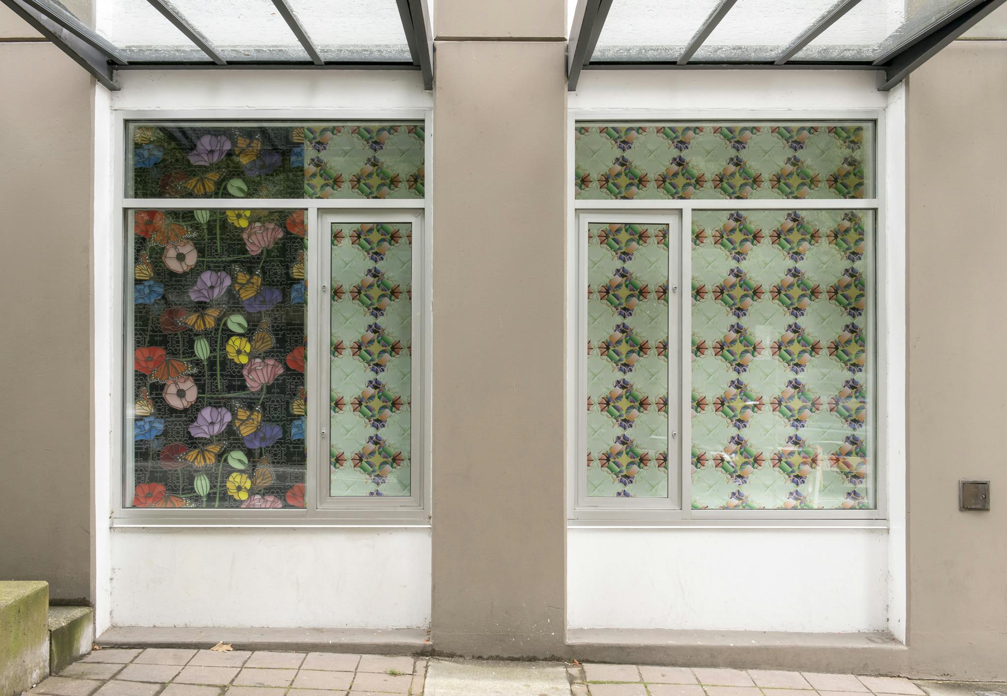 Exterior of the Contemporary Art Gallery displaying the work of Julian Yi-Zhong Hou. Two windows displaying two types of boldly patterned paper. 