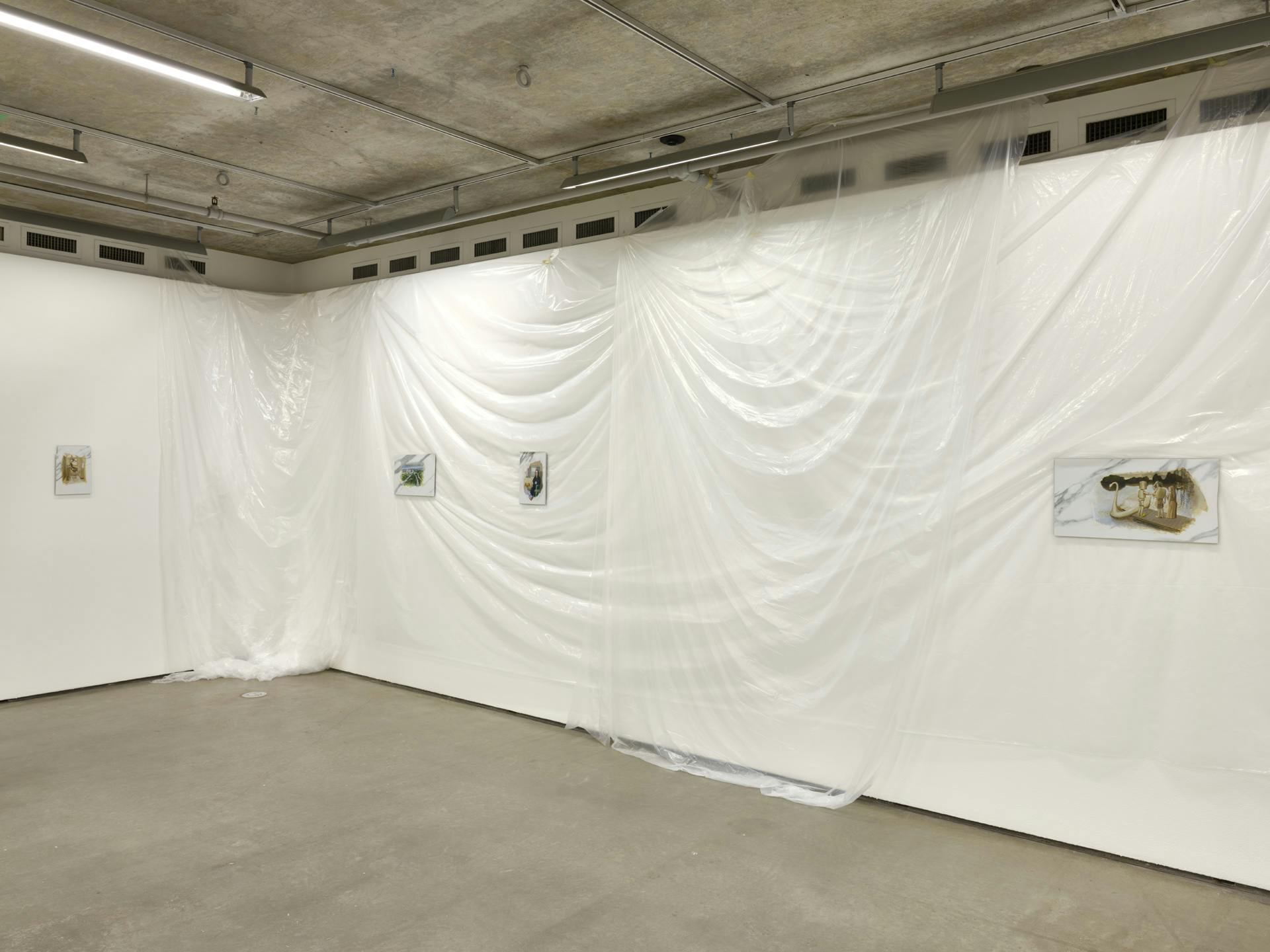Four small paintings on faux-marble tiles hang along a gallery wall draped with translucent plastic sheets.