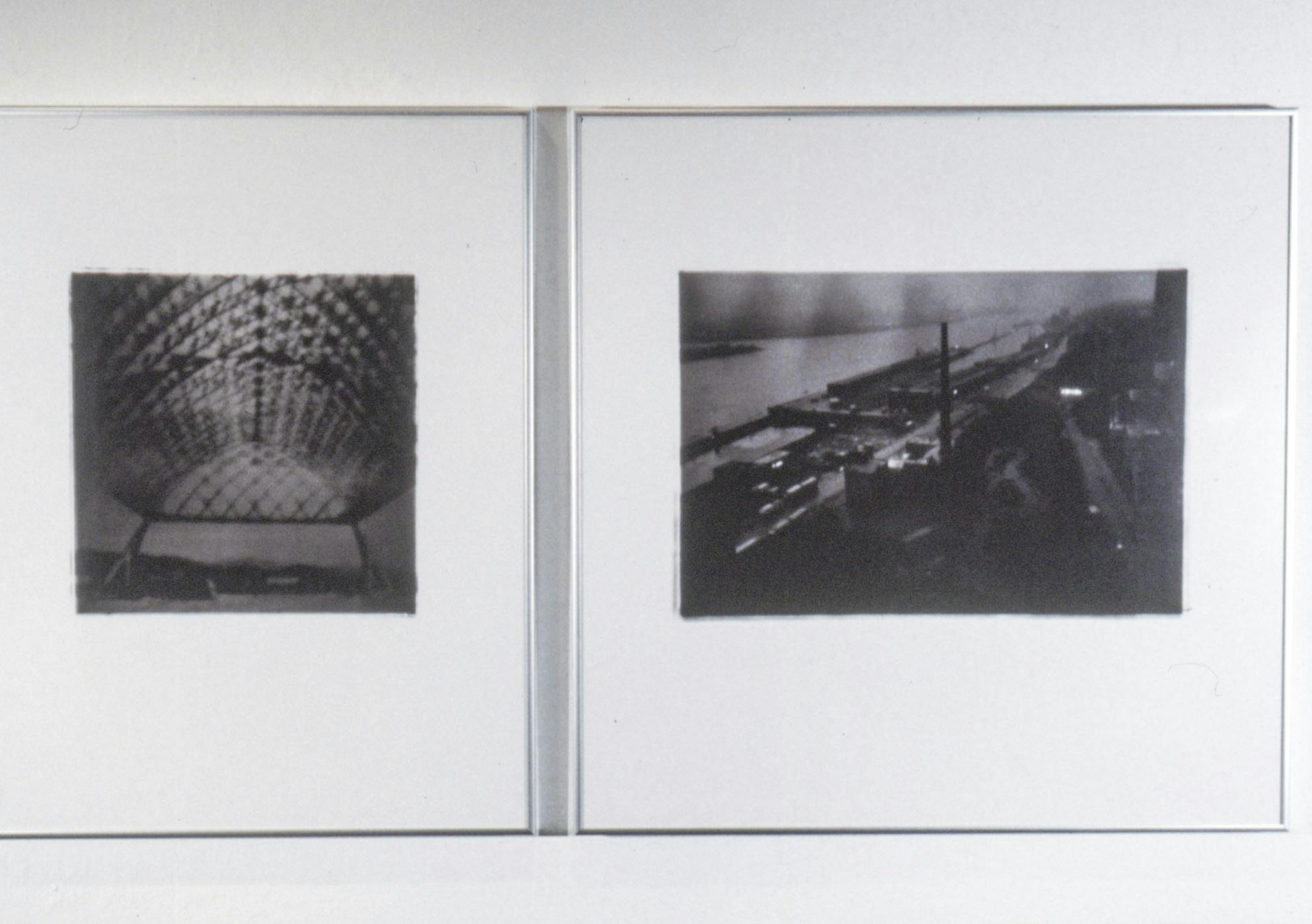 A closeup of two black and white photos in silver frames. One shows a complex gridded-arch ceiling, and the other shows a bird's-eye view of a shipyard. 