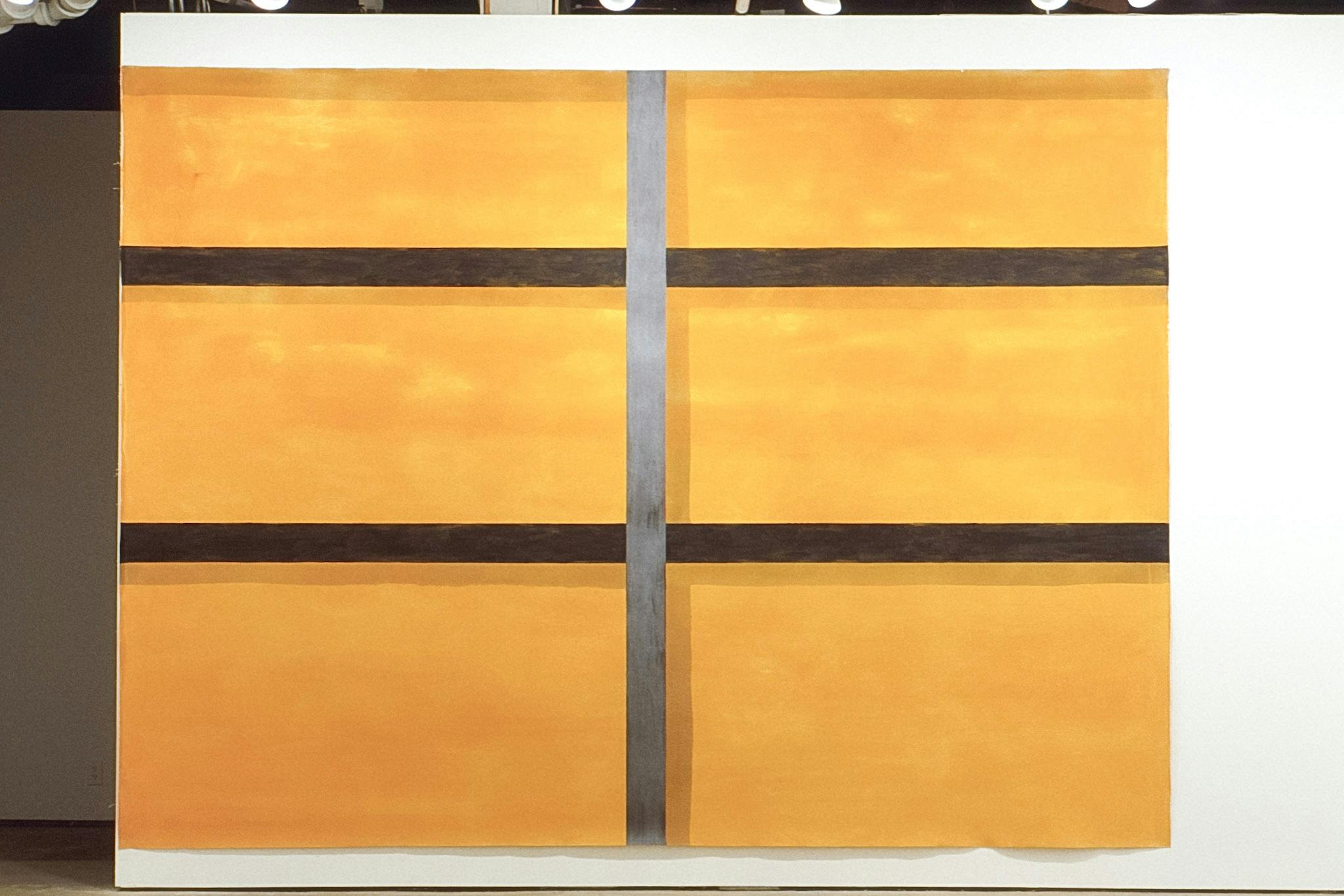 A large painting is installed on a gallery wall. The painting shows a close-up image of a grid made of two brown horizontal lines and one gray vertical line. The cells are painted in light orange. 