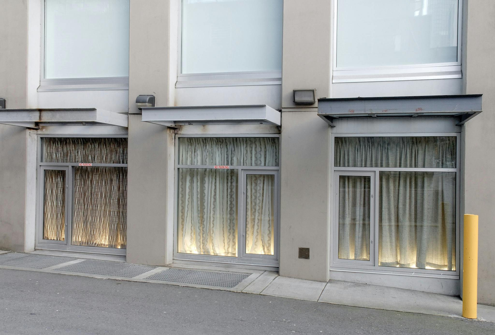 CAG’s window spaces are covered by the fabric installation by Derek Brunen. Each of two cream-coloured curtains and one brown curtain covers an entire window. 