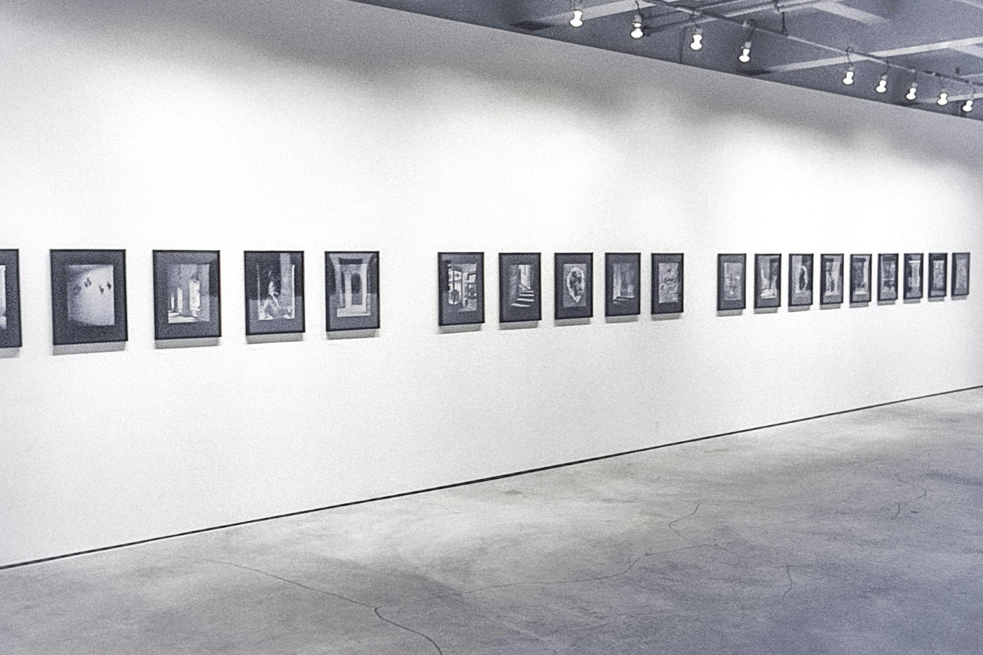 Three separate groups of photos in black frames. The photos are all black and white and show doorways, stairs, and windows. A total of 19 photos are visible in the space.