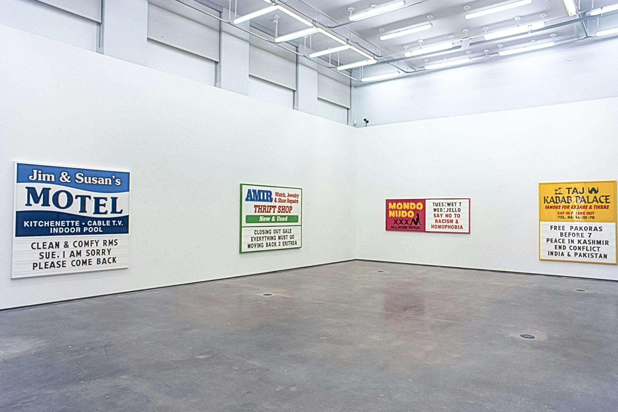 Ken Lum’s works are mounted on the gallery walls. They are text based two dimensional works with colourful advertisement posters. Their sizes vary, but many of them are larger than human scale.