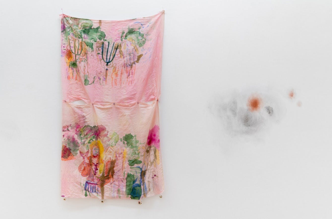 Installation image of Tiziana La Melia's fabric-based works. Paints and threads are embedded in a piece of pink fabric.