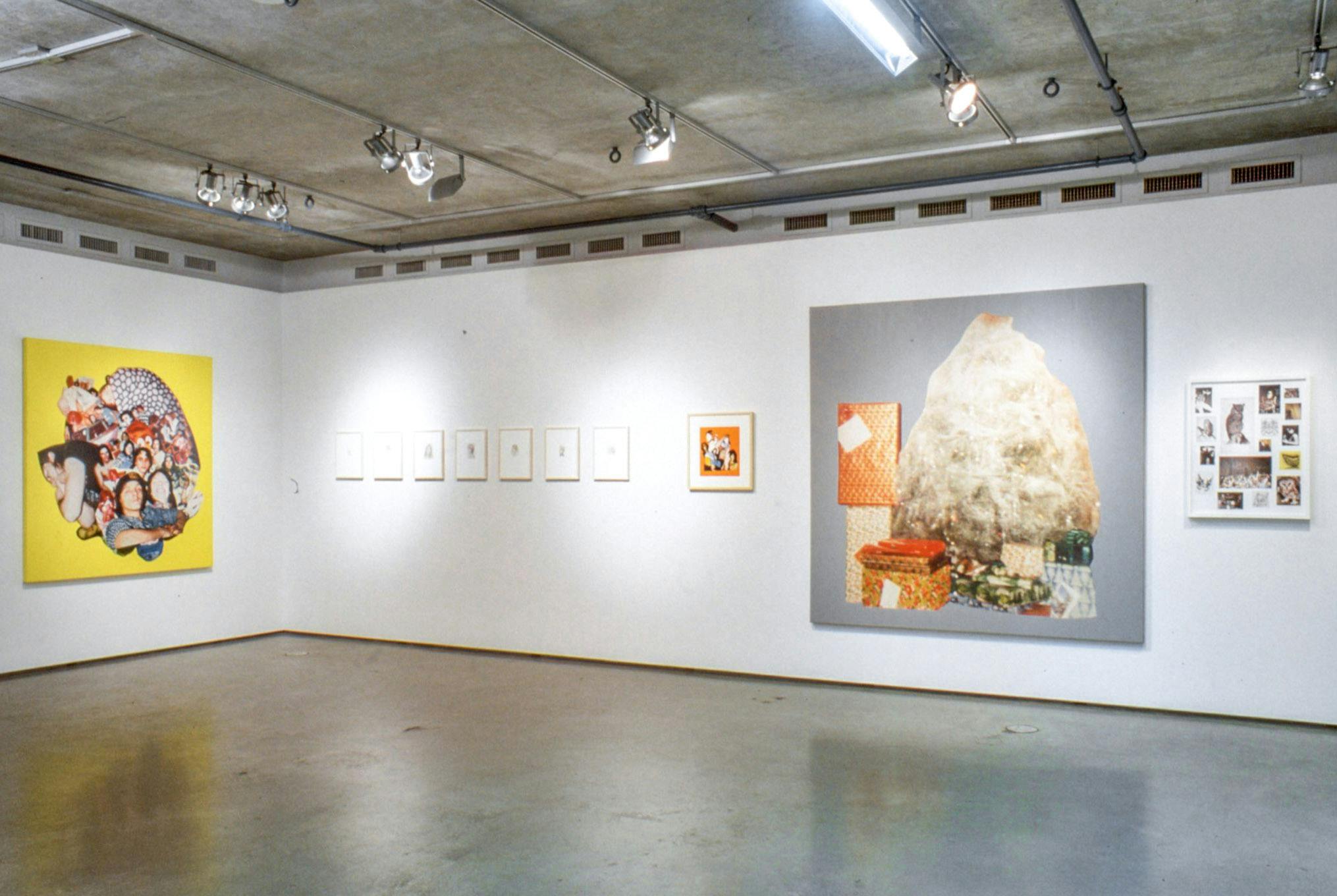 Installation image of works by Steven Shearer. Various-sized collage pieces and paintings are mounted on two walls. Among these works, there is a large-size collage work, which shows piles of wrapped gifts on a grey background. 