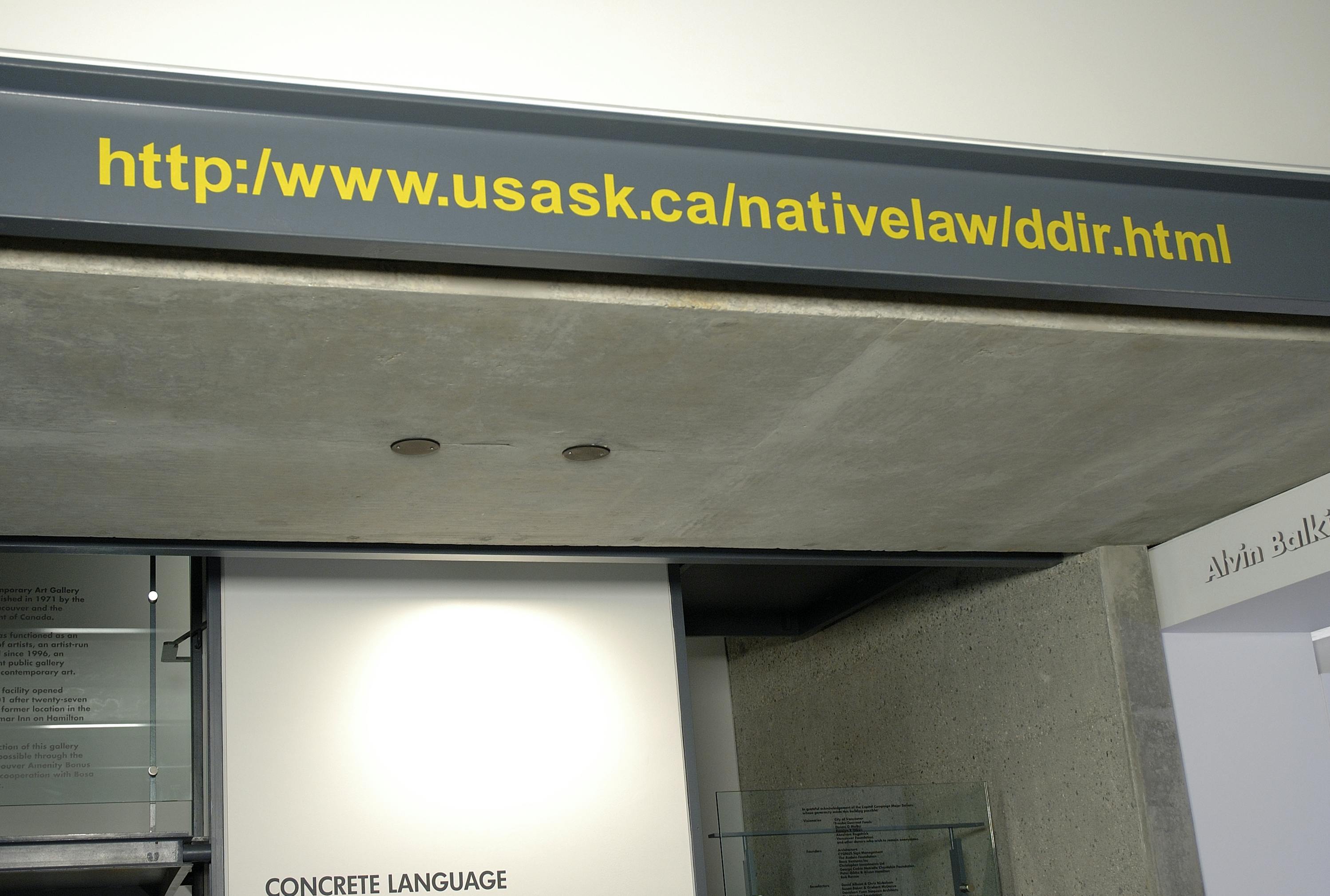 In CAG’s lobby, a URL is printed on the grey steel beam that is attached to the wall. The URL is http://www.usask.ca/nativelaw/ddir.html and it appears in yellow letters. 