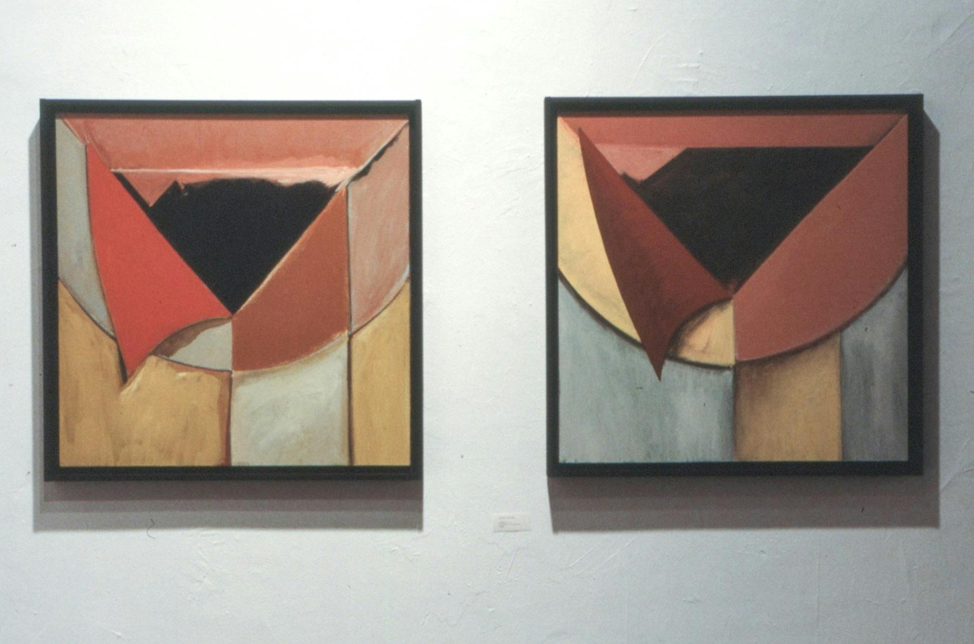 A closeup of 2 paintings in black frames. Both are nearly identical, but are painted in slightly different colours. Both show a half-circle with vertical strips, and a black triangle in the centre.