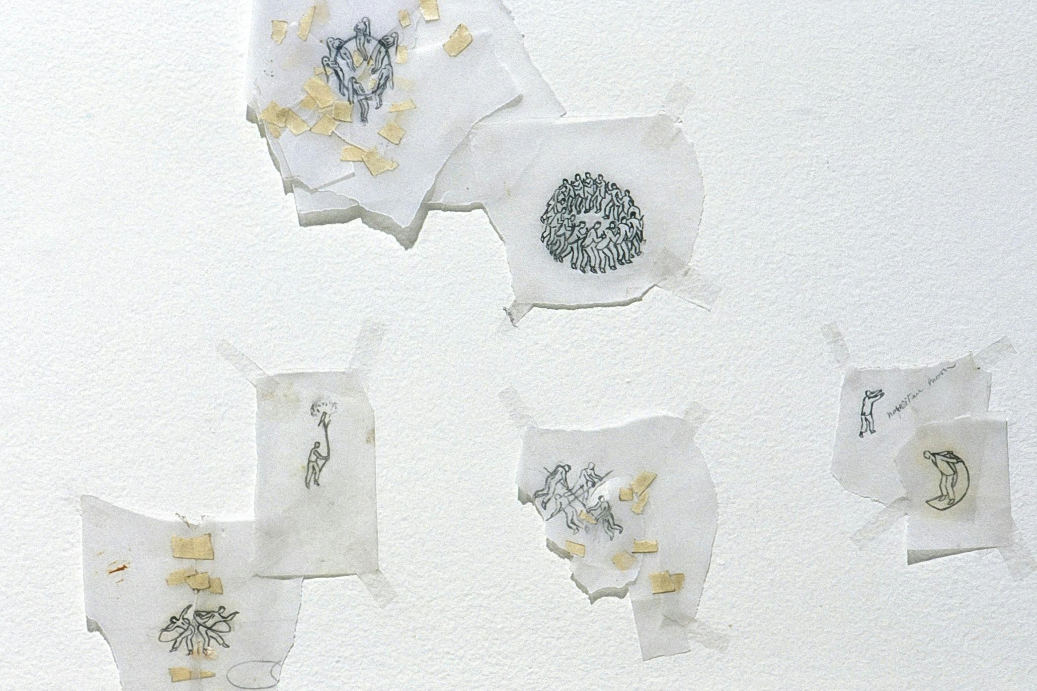 This is a close-up view of small drawings that are taped to the gallery wall. On the sheets of torn trace papers, black line drawings of various human figures and activities are depicted. 