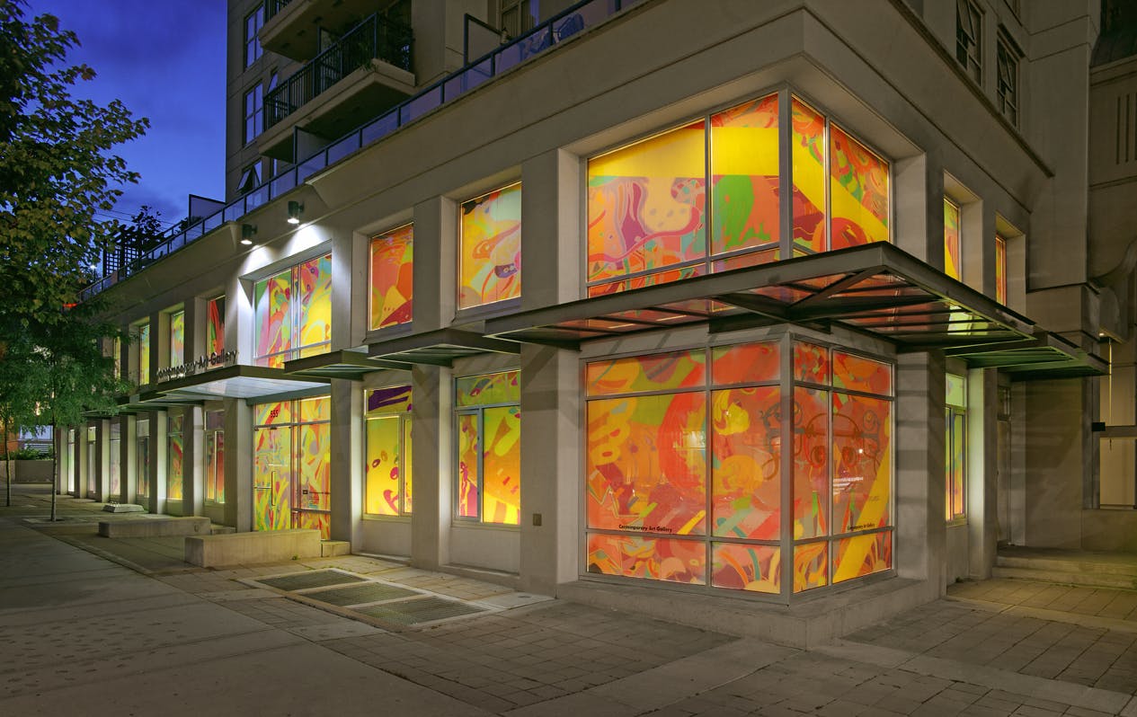 Installation image of graphic design work on the exterior of the CAG. Both ground-level and second-street windows are entirely covered by the vinyl, on which colourful abstract image is printed. 