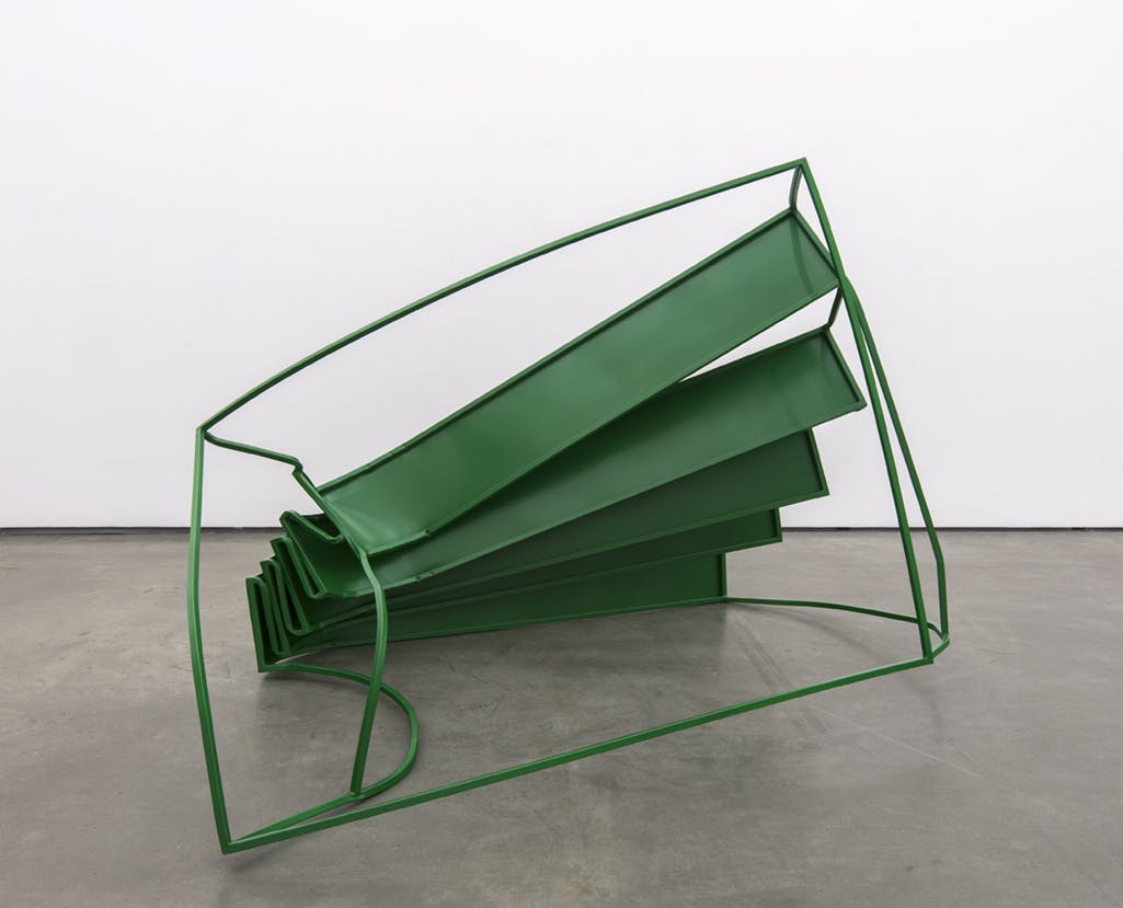 A free-standing, steel sculpture installed on a gallery floor. The entire sculpture is painted green and its shape resembles a bent, distorted staircase.