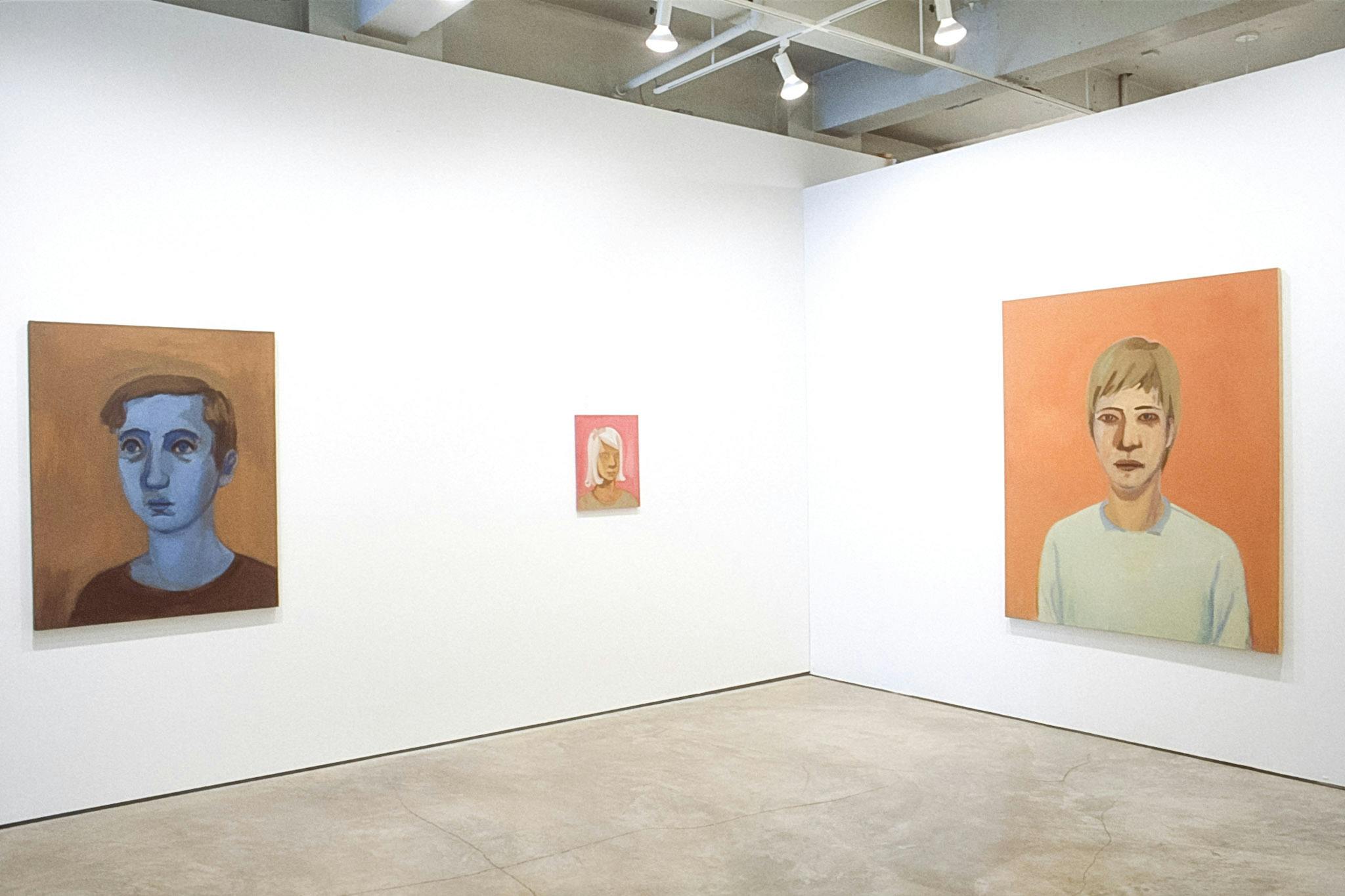 Three portrait paintings are exhibited on the galley walls. The left one is a blue-skinned man, the tiny one in the middle is a woman with grey hair. The one on the right is orange. 