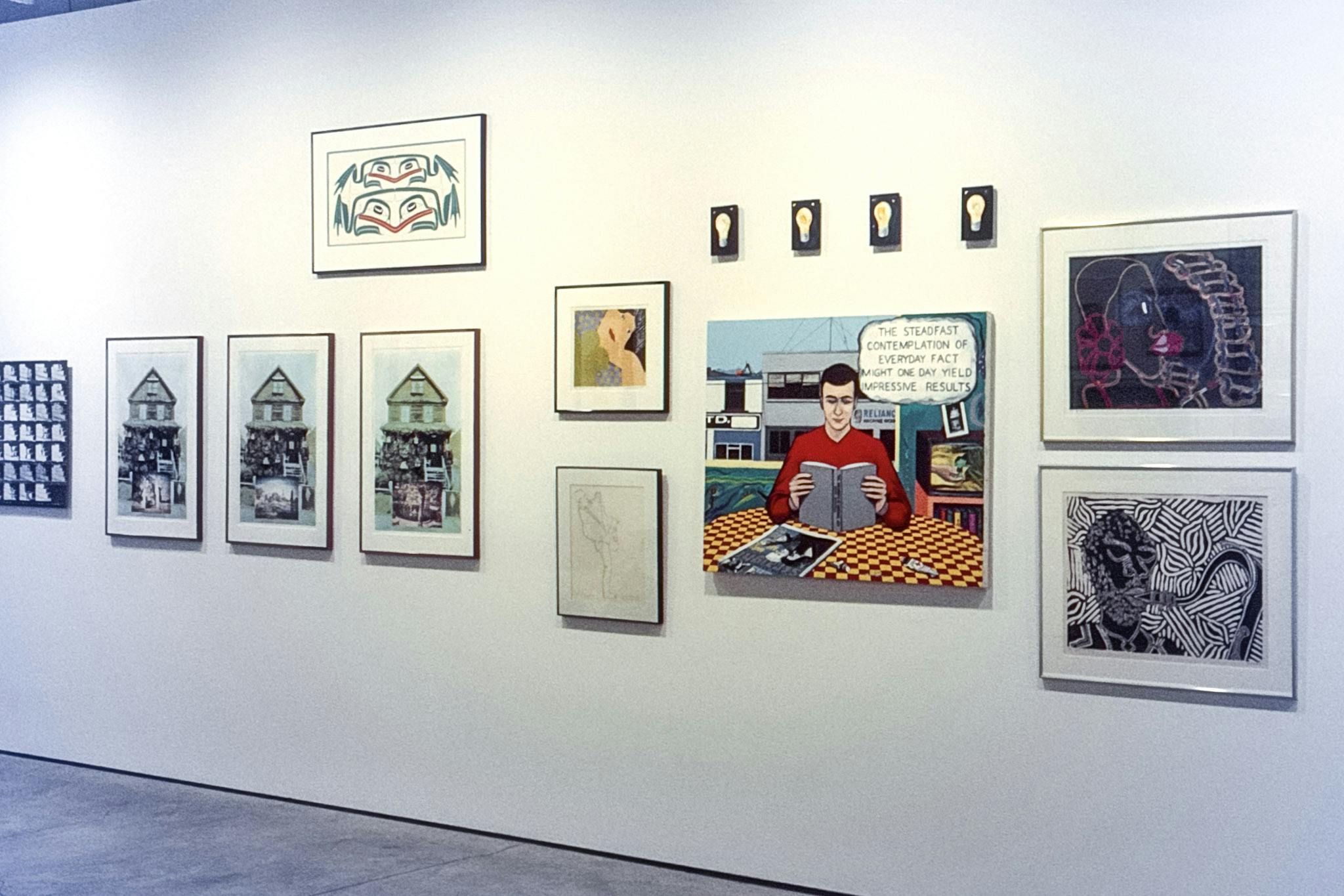A photo of various artworks mounted on a gallery wall. One painting depicts a man reading a book and thinking, “The steadfast contemplation of everyday fact might one day yield impressive results.”  