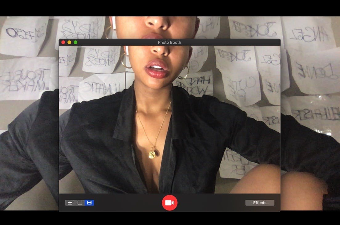 A portrait of Chipo Chipaziwa. The image is a screenshot of an open Photobooth window. The bottom half of her face and torso are within frame.