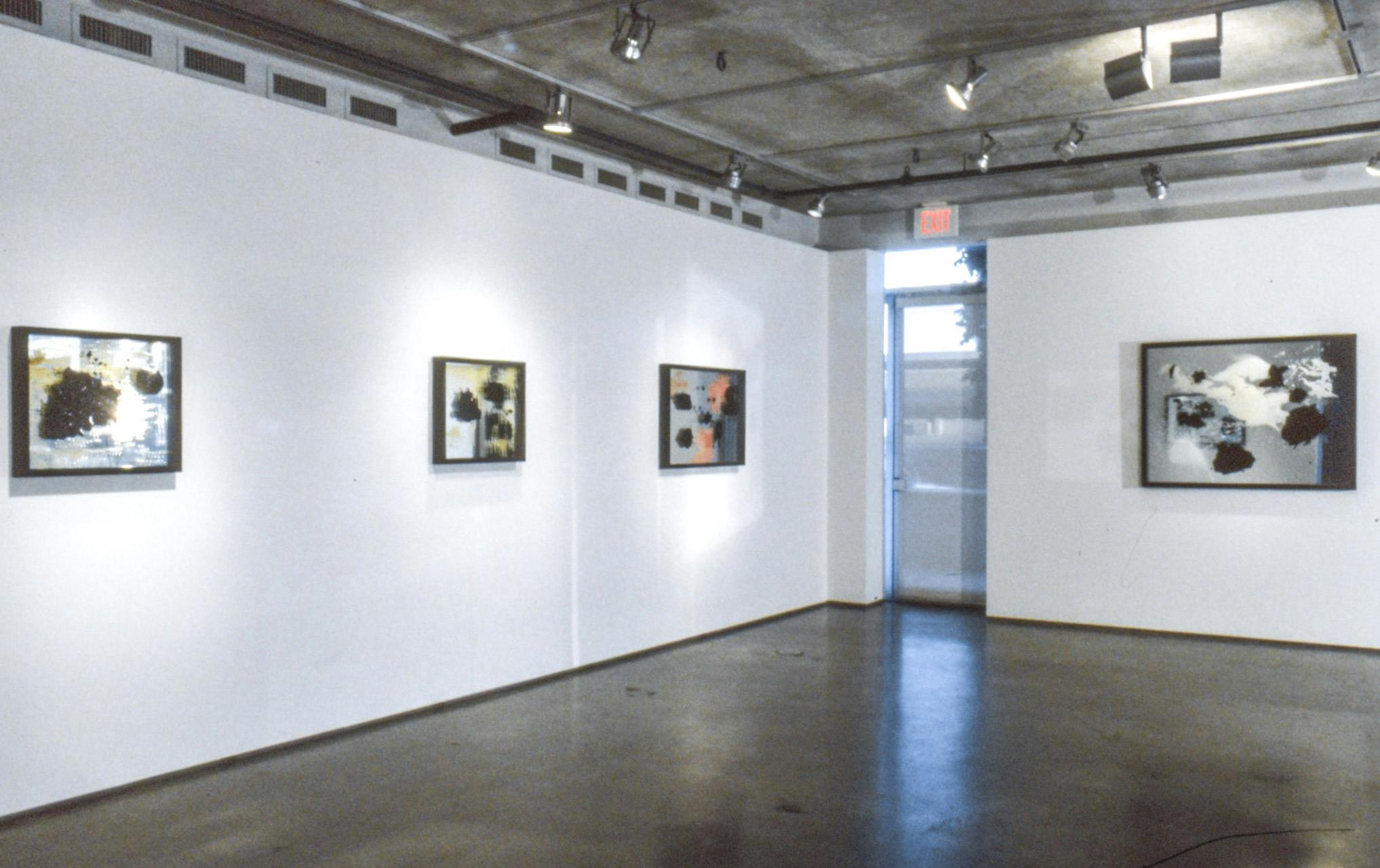 Installation image of Marina Roy’s paintings. Paintings of abstract shapes are made on the mirrors. Three paintings are mounted on the left wall and a larger painting on the far wall. 
