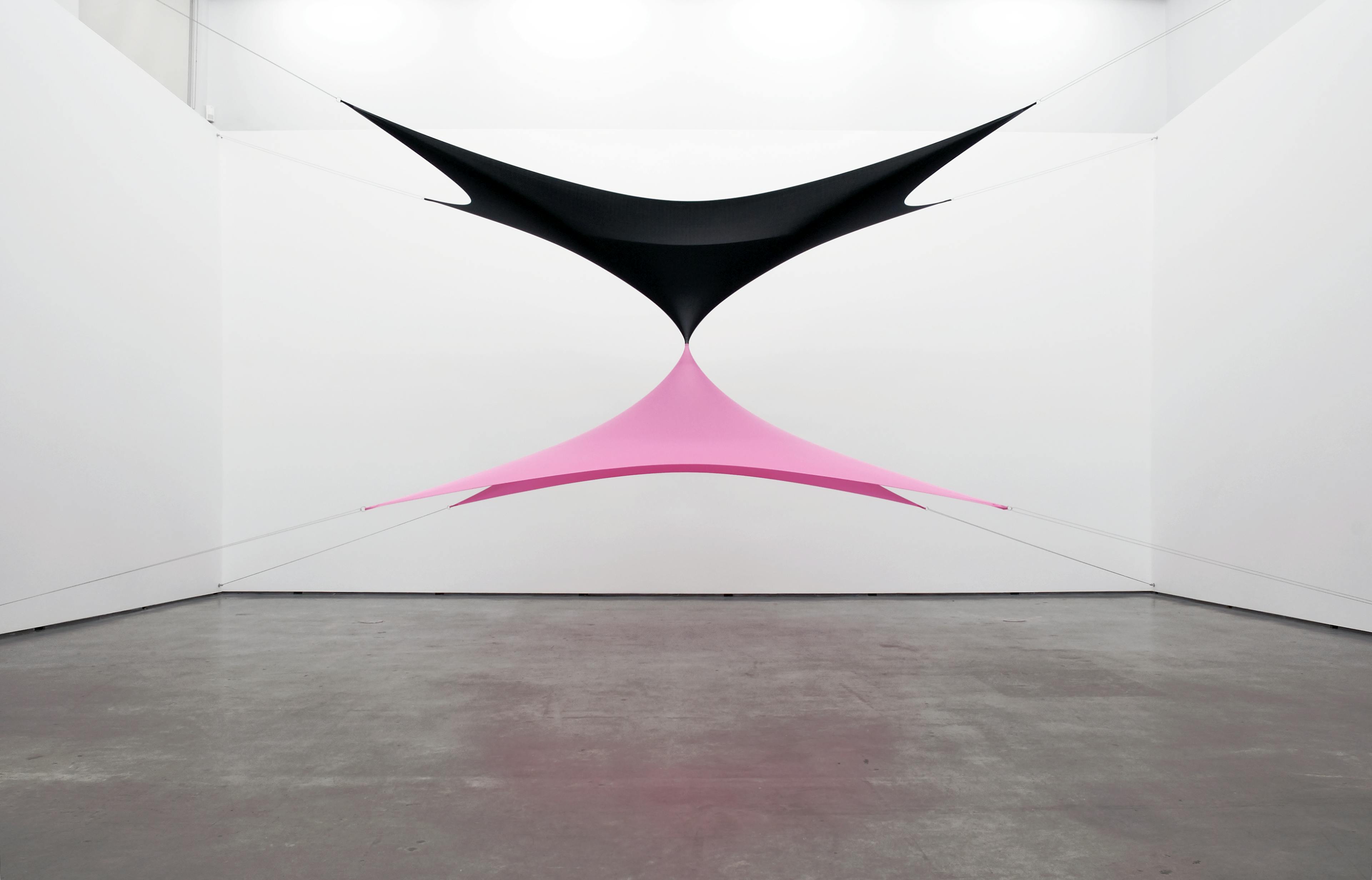 Black and pink fabric are installed in a gallery space. They both are stretched to make tent-like shape. Black fabric is suspended from four corners of ceilings, and pink fabric is suspended from four corners of the floor.