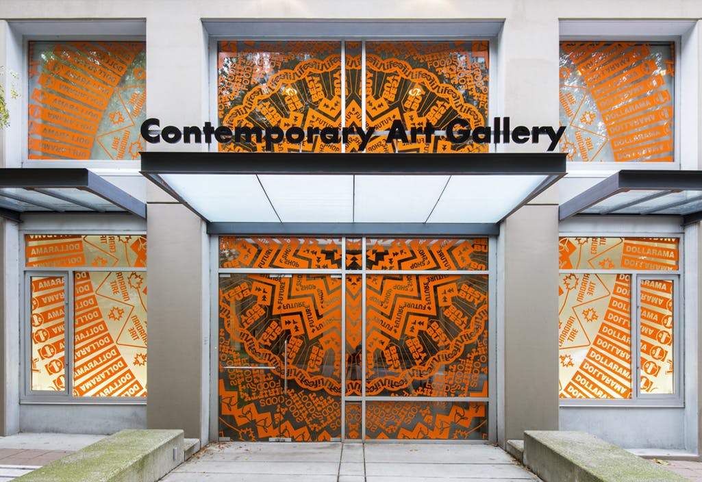 Exterior view of CAG’s front entrance installed with a pattern in cut-vinyl by Gunilla Klingberg. Covering the entirety of the doors, close inspection reveals that the pattern is made of brand logos.