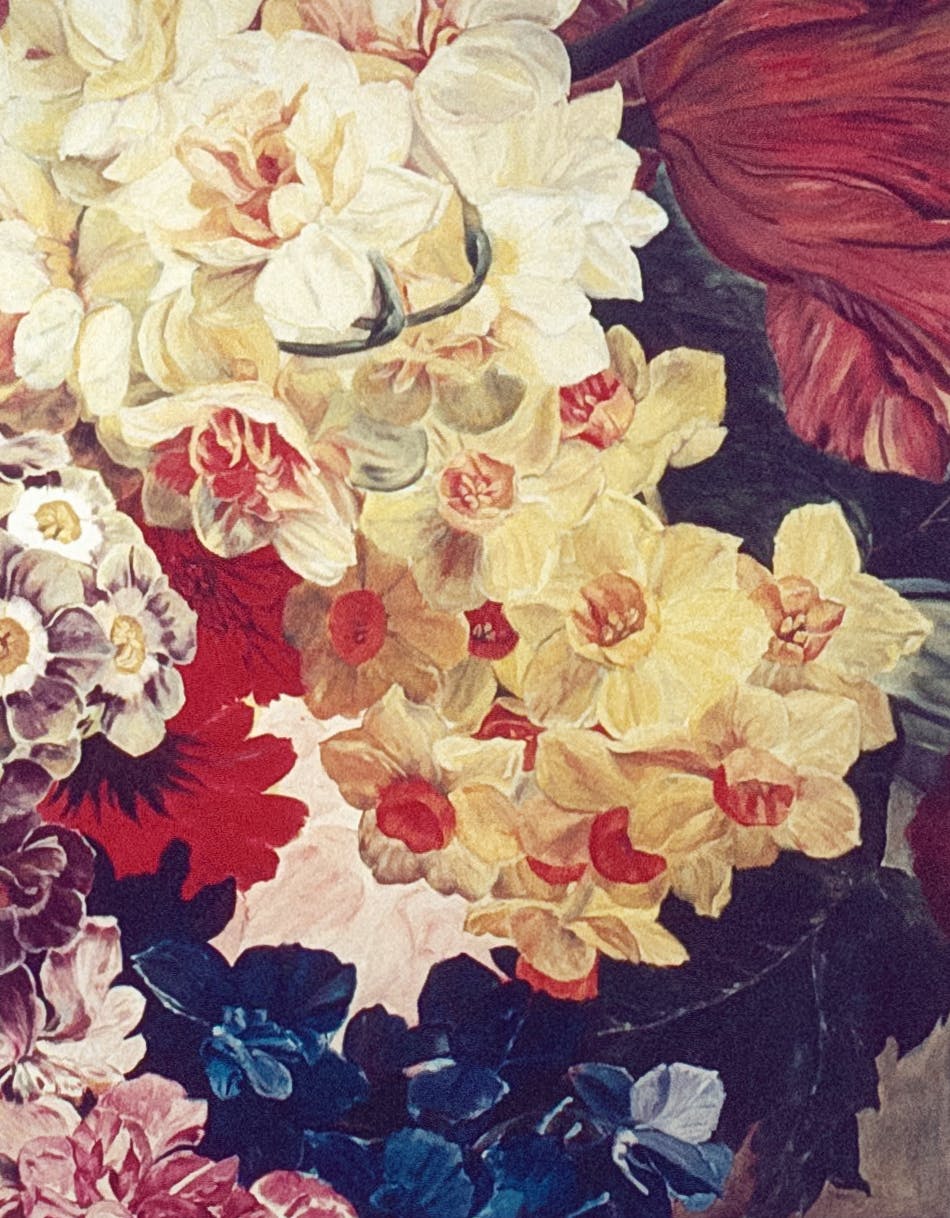 A close view of a painting of overlapping flowers. The flowers are red, yellow, blue and pink. 